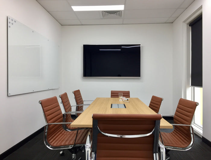 White magnetic glassboard in a bright boardroom
