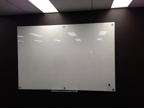 Glass Dry Erase Board in an Office Environment. Perfect glass surface white board. Professionally installed wall anchors for long term use