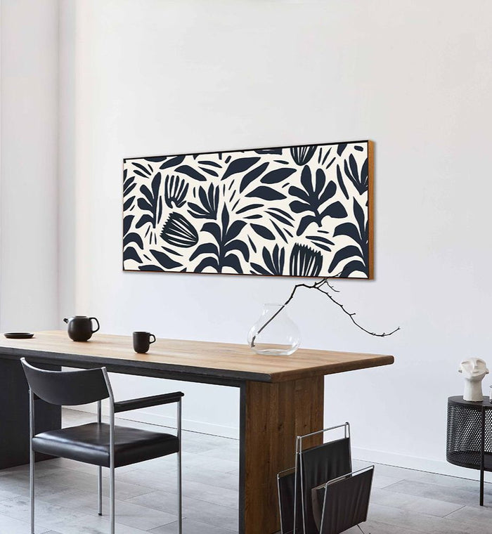Framed SANA acoustic art panel with navy botanical print above a desk