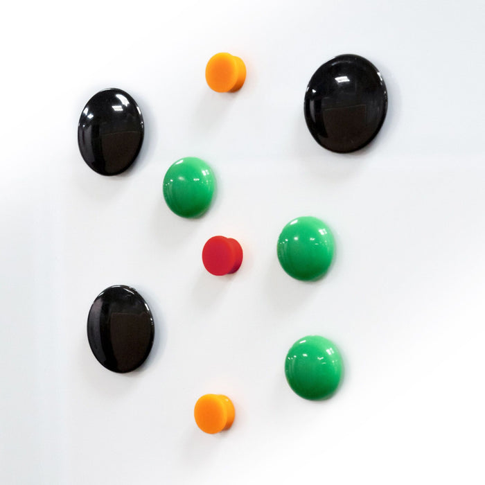 Coloured button and disc magnets on a white glassboard